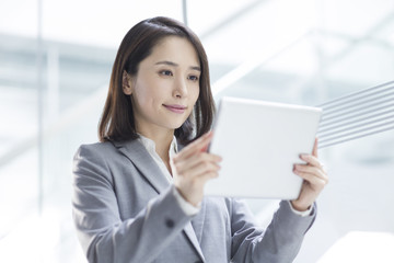 Young businesswoman using digital tablet