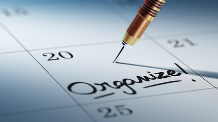 Concept image of a Calendar with a golden dart stick.. The words