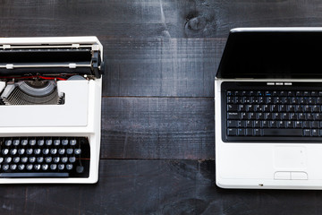 The image represents a retro typewriter and a laptop on a dark wood background conceptualizing that...