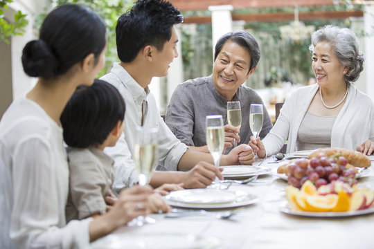Happy multigenerational family eating outdoors - Powered by Adobe