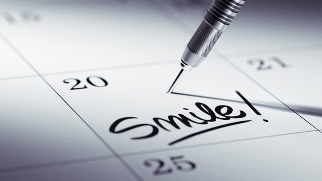 Concept image of a Calendar with a golden dart stick.. The words