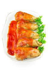 Cabbage roll with tomato sauce and parsley in plate, isolated on white background