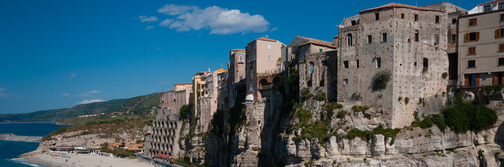 Fototapeta na wymiar Italian houses fronting the sea on cliff over coast of Tropea