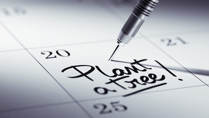 Concept image of a Calendar with a golden dart stick.. The words