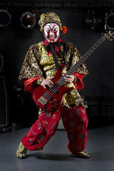 Man In Ceremonial Costume Playing The Electric Guitar