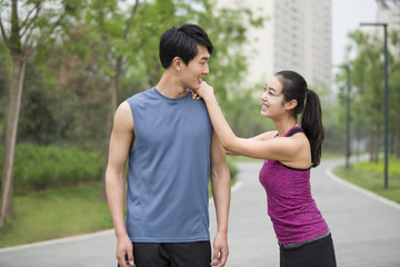 Young couple taking a break from exercise to talk