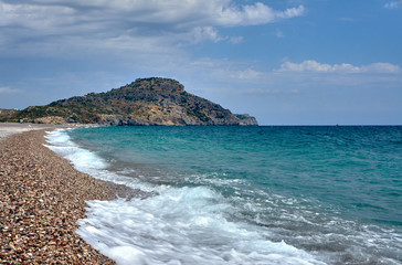 The stone beach and rock on the island of Rhodes.