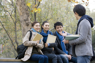 A group of college students talking with each other