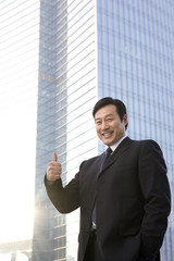 Businessman showing thumbs-up