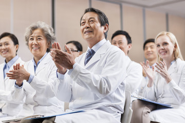 Fototapeta na wymiar Medical workers clapping in a meeting