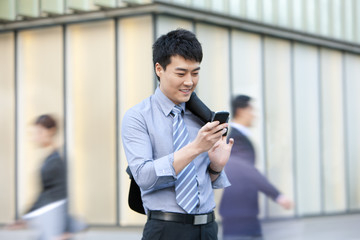 Chinese businessman using cellphone