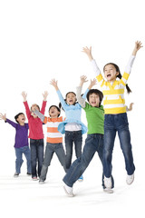 A group of children jumping up with excitement