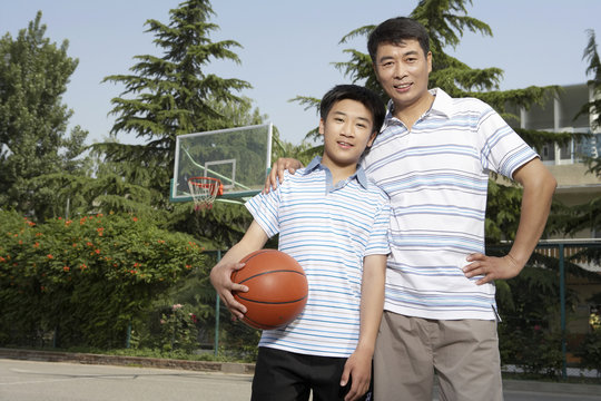 Father And Son On Basketball Court