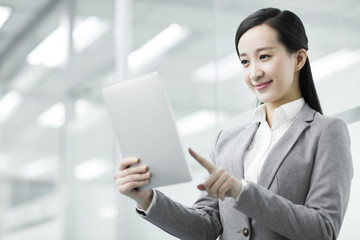 Young businesswoman with digital table