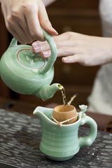 Female hand pouring tea