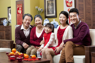 Happy family sitting in sofa during Chinese New Year
