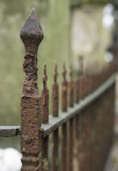 corner view on a rusty fence blurred in the distance - 99578958