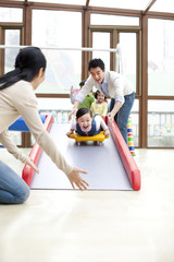 Little girl going down a slide in kindergarten