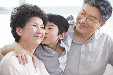 Cute grandson kissing grandmother