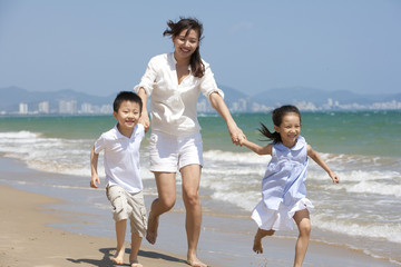 Family running on the beach