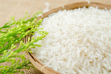 Raw white rice in weave basket.