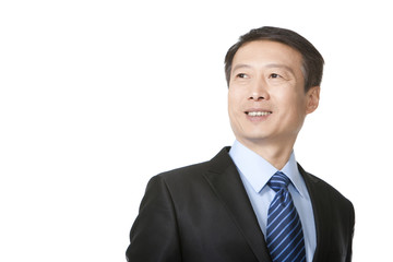 Mature businessman looking away