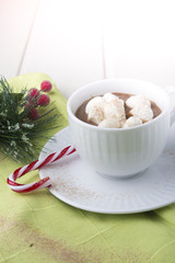 A big cup of hot cocoa with marshmallows decorated with striped