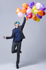 Hip young man with balloons