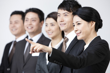 Joyful business coworkers pointing and looking at view