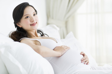 Pregnant woman resting in bed