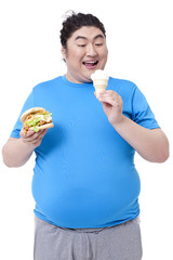 Greedy Chubby man eating burger and ice cream