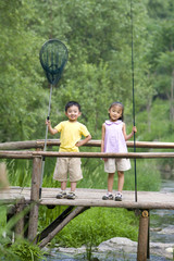 Portrait of two children fishing