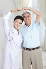 Doctor and patient doing a heart shape gesture