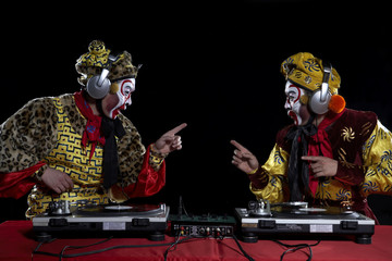 Men In Ceremonial Costume Using Turn-Tables © Blue Jean Images