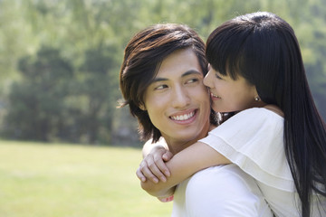 Fototapeta premium Young couple having fun in park