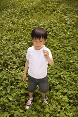 Portrait Of Young Boy Standing In A Park
