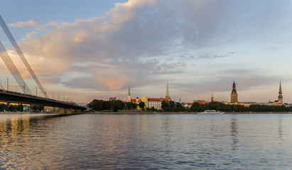 Fototapeta na wymiar Old Riga city. View from the left bank of the Daugava river. Riga is the capital and largest city of Latvia, a major commercial, cultural, historical, tourist and financial center of the Baltic region