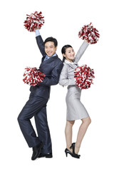  A team of businesspeople cheering with pompoms