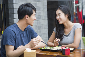 Happy young couple having lunch