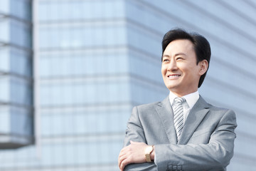 Confident businessman arms crossed