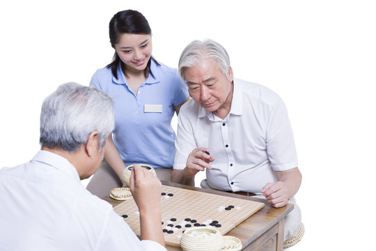 Senior men playing go in nursing home