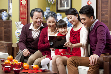 Family taking self portrait shots with digital tablet