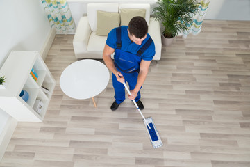 Janitor Cleaning Hardwood Floor With Mop At Home