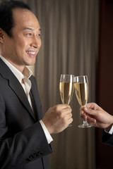 Man toasting woman with champagne