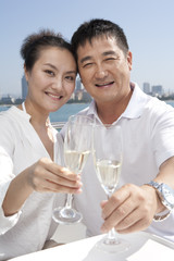 Happy Couple Drinking Champagne on a Yacht