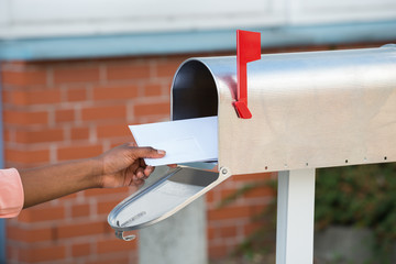 Person Putting Letters In Mailbox