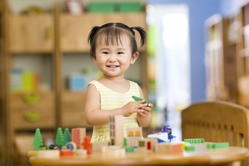 Little girl playing with toys at home