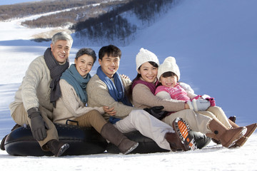 Fototapeta na wymiar Family having fun in snow