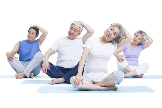 Senior adults practicing yoga
