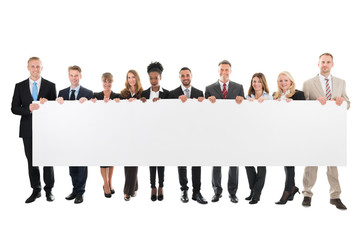 Doctors And Nurses Standing Against White Background